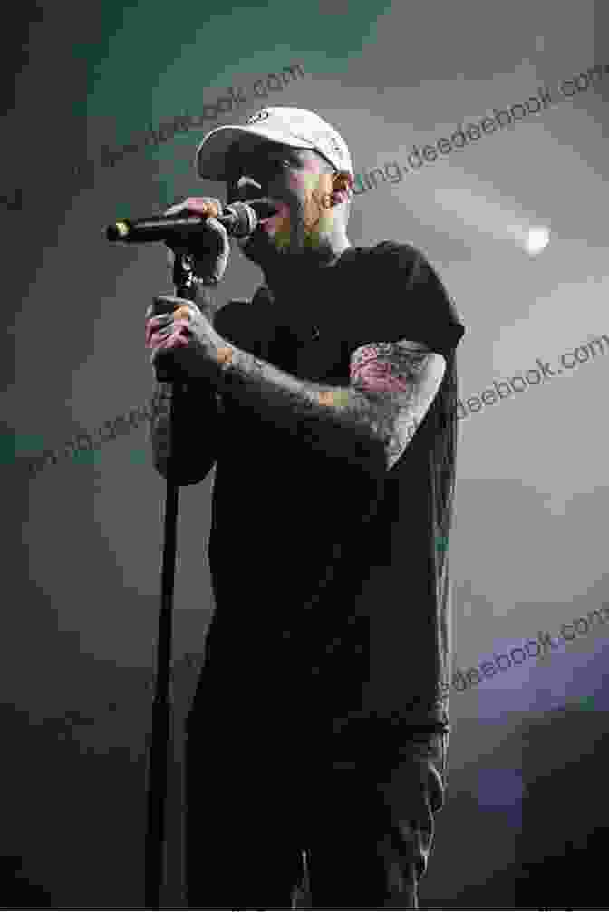 Mac Miller Performing On Stage, Wearing A Casual Outfit And Holding A Microphone, With A Vibrant Light Show In The Background. The Of Mac: Remembering Mac Miller